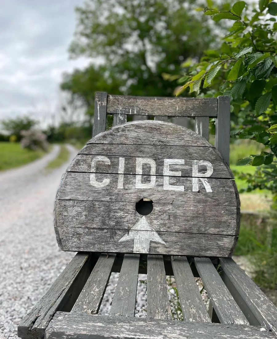 A handmade cider sign beside the lane leading to Loader’s Cider